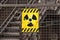 Radioactive warning sign on rusty fence