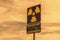 a Radioactivity and chemical hazard street sign with toxic clouds on the background: pollution and danger concept