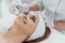 Radiofrequency facial skin lifting. Hardware cosmetology RF lifting procedure and hardware massage