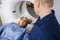 Radiologist Preparing Female Patient For MRI Scan In Hospital