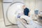 Radiologist Putting Coil On Patient\'s Head Undergoing MRI Scan
