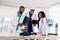 Radiology, people and medicine concept - group of three African doctors, surgeon and radiologists, looking at and