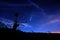 radiotelescopes silhouettes under night starry cloudy sky