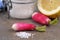 Radish next to fleur de sel and a lemon close-up on a gray background