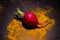 Radish and turmeric with shadow on black background