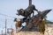 Radium Hot Springs, British Columbia, Canada - Janurary 20, 2019: A confused bighorn sheep baby ewe stands on top of a statue of