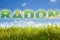 Radon, the natural radioactive gas that comes from the earth - concept with radon text over a green mowed lawn