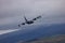 RAF Royal Air Force Lockheed C-130 Hercules transport plane carrying out low level flying in the United Kingdom