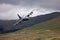 RAF Royal Air Force Lockheed C-130 Hercules transport plane carrying out low level flying in the United Kingdom