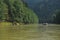 Rafting on the Dunajec River in the Pieniny National Park on wooden folding shuttles tied with a rope. Rafters paddling on a rapid