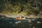 Rafting extreme team splashing the waves on river in Carpathians. Adventure travel