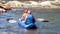 Rafting, kayaking. Two athletes in sports equipment are sailing on a rubber inflatable boat. Teamwork.