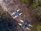 Rafting kayaks on bank of mountain river with rocky shore. Aerial top view