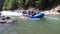 Rafting on Rough Mountain River. Adventure Team in Rubber Boat Goes Down Stream