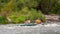 Rafting trip. Two rowers are rafting down the river in a rubber inflatable boat