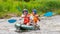 Rafting trip. Two rowers are rafting down the river in a rubber inflatable boat