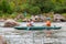 Rafting trip. Two rowers are rafting down the river in a rubber inflatable boat