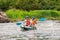 Rafting trip. Two rowers are rafting down the river in a rubber inflatable boat