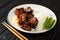 Rafute Okinawan braised pork belly dish which is simmered in Awamori, black sugar and soy sauce closeup in the plate. Horizontal