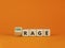 Rage or courage symbol. Turned a cube and changed the word `rage` to `courage`. Beautiful orange background. Copy space. Busin