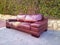 Ragged leather sofa dumped on a street