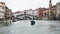 Raghetti boat and Rialto Bridge in Venice in rain