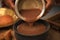 ragi malt, finger millet porridge served in a traditional mud pot served  closeup