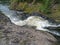 The raging falls on the Suna River in summer day. Karelia, Kivach