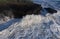 Raging storm waves smashing into rocks