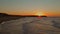 Raging waves hit the beach in the golden hour