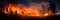 raging wildfire consuming a vast expanse of pristine forest, with flames reaching high into the sky. Generative AI