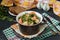 Ragout with turkey and carrots in a pot on a dark background