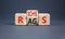 Rags or riches symbol. Concept word Rags Riches on wooden cubes. Beautiful grey table grey background. Business and rags or riches