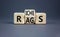 Rags or riches symbol. Concept word Rags Riches on wooden cubes. Beautiful grey table grey background. Business and rags or riches