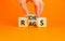 Rags or riches symbol. Concept word Rags Riches on wooden cubes. Beautiful orange table orange background. Businessman hand.