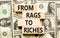 Rags or riches symbol. Concept words From rags to riches on wooden blocks. Dollar bills. Beautiful background from dollar bills.