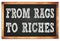 FROM RAGS TO RICHES words on black wooden frame school blackboard