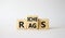 Rags vs Riches symbol. Wooden cubes with words Rags and Riches. Beautiful white background. Rags vs Riches and business concept.