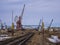 Rail road tracks under the gantry cranes on the berth of sea merchant port