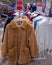 Rail of secondhand fur coats for sale in a thrift store or charity shop