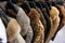 Rail of Secondhand Fur Coats For Sale in a Thrift Store Shop