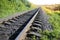 Rail tracks in the green field. Railway transport industry. Empty road on summer day. Travel lifestyle motivation photo