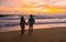 Railay Beach Krabi Thailand, a couple of men and woman on the beach at susnet