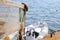 Railing Draped in Fishing Net on Dock with Boat