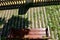 railing fencing rest area above the vineyard using red bricks creates a regular airy grid paving in stripes overgrown with lawn