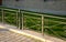 railing historical park black iron cast metal low paving lawn grass green beige