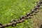 Railings from an ancient metal chain. Closeup of an old chain railings in a public park