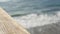 Railings of wooden pier, waterfront boardwalk, California beach USA. Defocused ocean, sea waves.