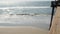 Railings of wooden pier, waterfront boardwalk, California beach USA. Defocused ocean, sea waves.