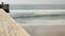 Railings of wooden pier, waterfront boardwalk, California beach USA. Defocused ocean, sea waves.